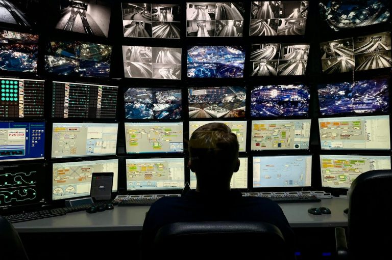 CCTV Surveillance A person monitoring multiple screens displaying surveillance footage and data.