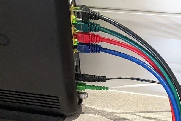 Business Broadband Close-up of a device with colour-coded audio cables connected to its ports.